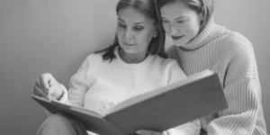 elderly woman and younger woman reading together