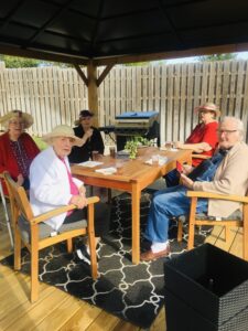residents sitting at table outside