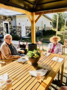 residents sitting at table outside