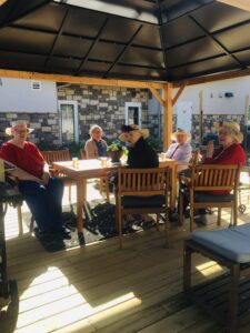 residents sitting at table outside