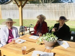 residents sitting at table outside