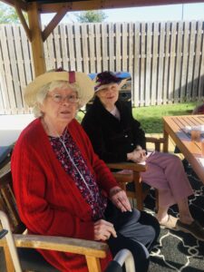 residents sitting at table outside