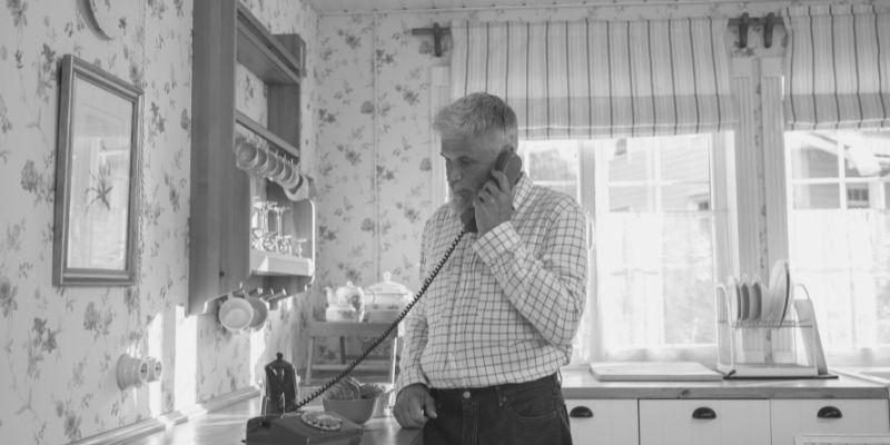 elderly man on landline phone