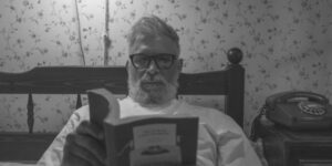 elderly man reading in bed
