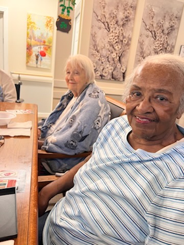 residents smiling at table