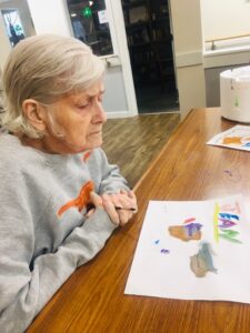 resident painting at table