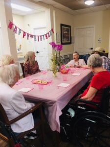 Birthday Party residents at table talking together