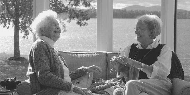 two elderly female friends laughing together